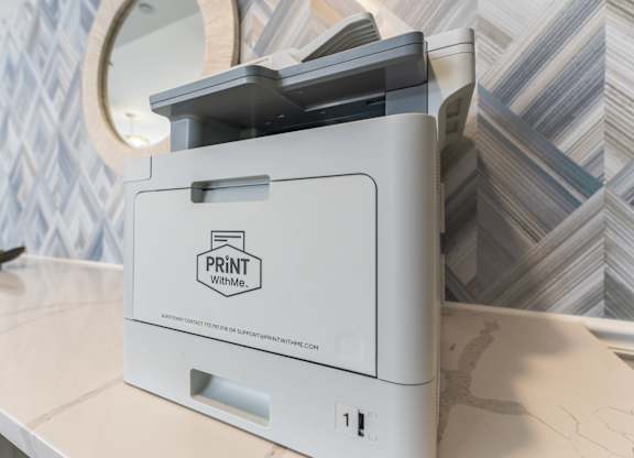 A white and black printer with the words "Print With Me" on it.