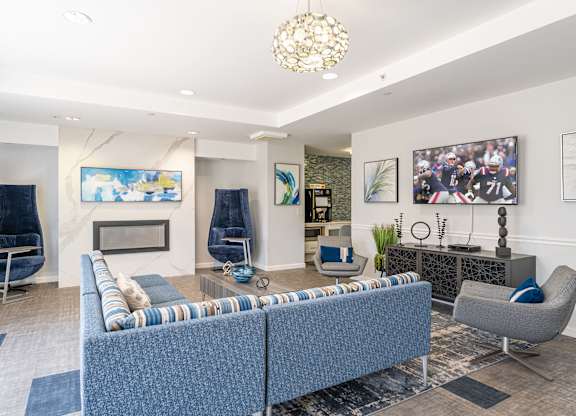 Parkside Commons community room with fire place and a blue sofa and a fireplace.