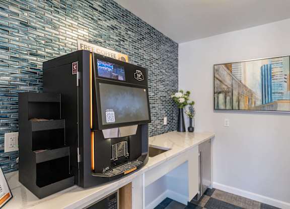 Sip With Me coffee machine with a digital display is on a counter.