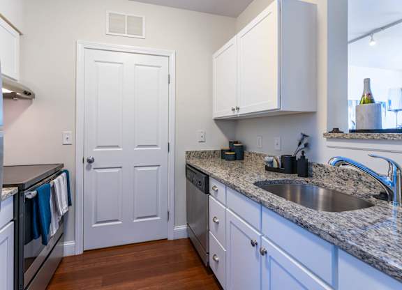 Parkside Commons kitchen with a white cabinetry and a stainless steel refrigerator.