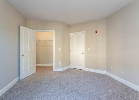Chelsea Place vacant apartments room with two doors and a carpeted floor.