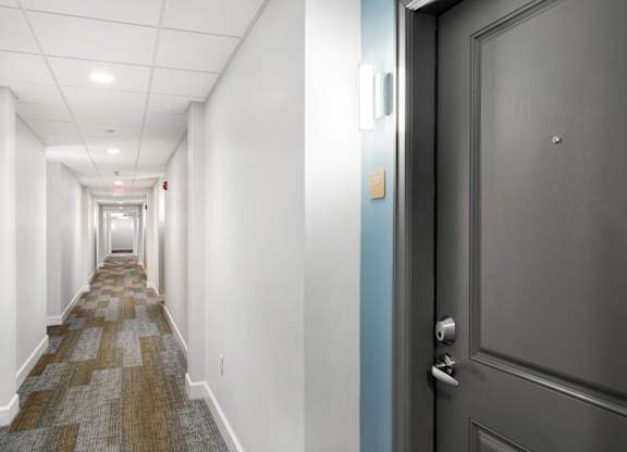 Parkside Commons hallway with a blue door and a carpeted floor.