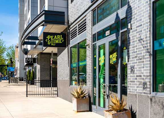 Pearl and time restaurant with green signboard and glass door.