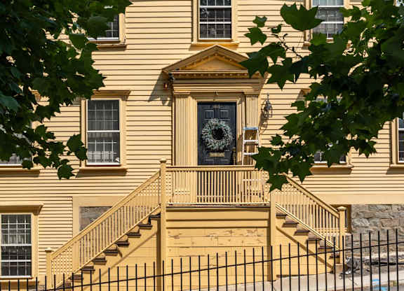 A house with a front porch and a wreath on the door.