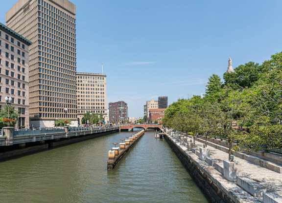 The river in Providence with a boat and buildings on both sides.