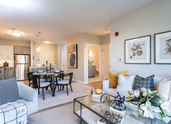 Large living space with dinner table and carpeted floor