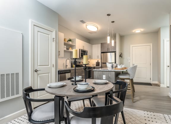 Large living space with dinner table and carpeted floor