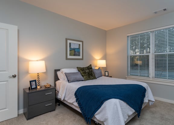 Two bedroom model apartment bedroom with plush carpeting