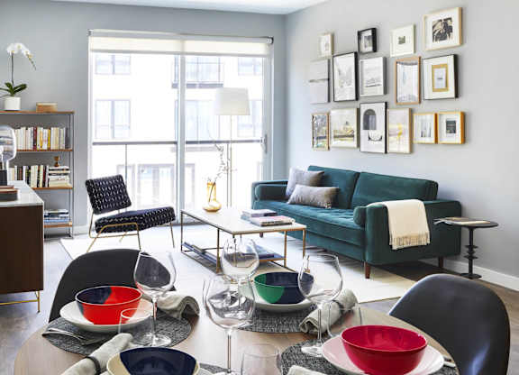 Living room with green couch, coffee table and bookshelf