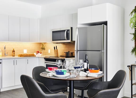 A modern kitchen with a table setting, model apartment