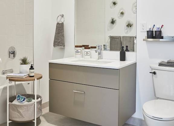 A white toilet sits next to a sink in a bathroom
