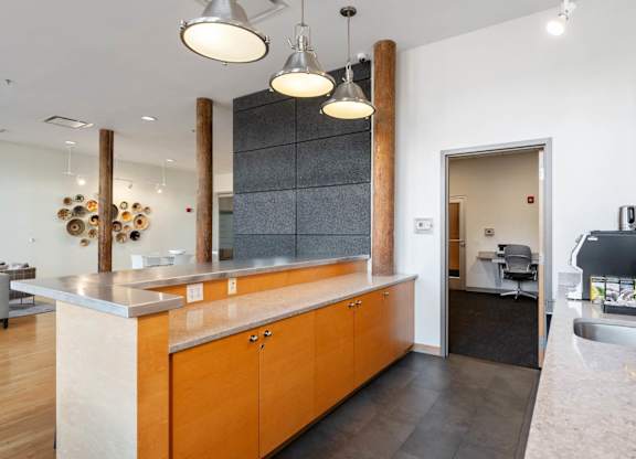 A kitchen with wooden cabinets and a large island.