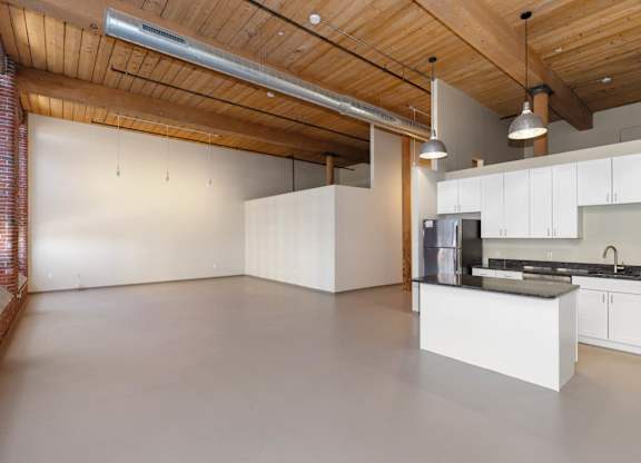 A kitchen with a white counter and cabinets.