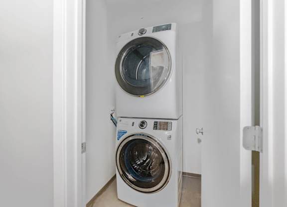 A white washing machine in a small room.