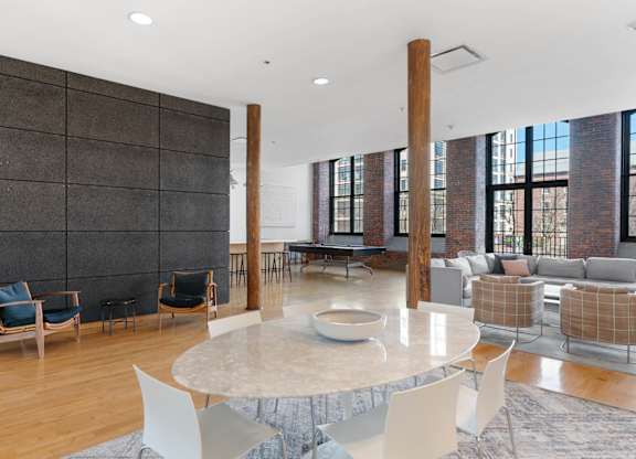 A modern living room with a large table and chairs.