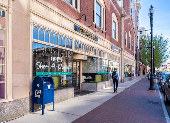 A street view with a person walking on the sidewalk.