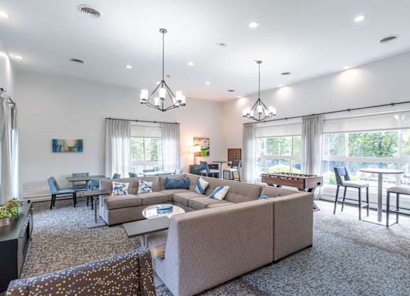a living room with a couch and a table with chairs