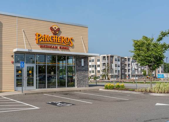 Pancheros Mexican Grill in the foreground with the Slade Farm apartment building visible across the parking area.