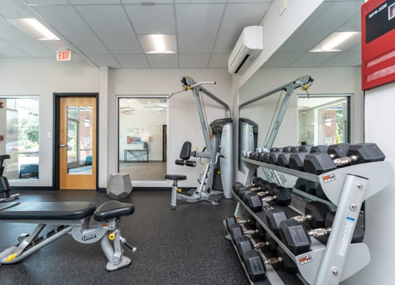 a gym with cardio equipment and weights at one mansfield ave