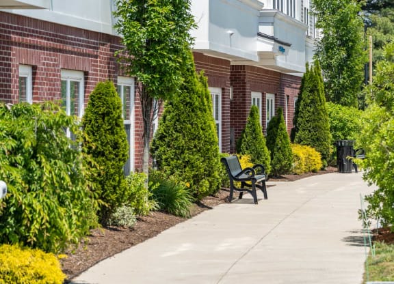 a bench on a sidewalk in front of a building