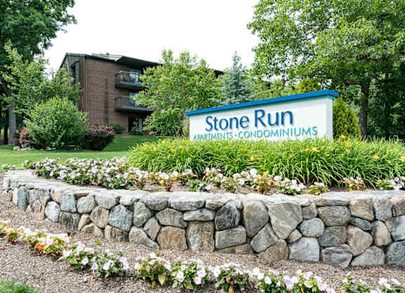 stone run entrance with flowers and plantings