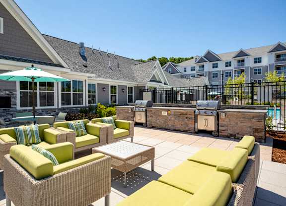 outdoor furniture overlooking pool deck & grills