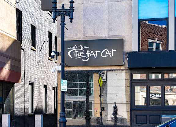 A street view of a building with a sign that reads