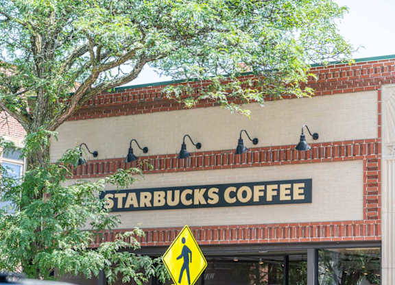 a sign on the front of a starbucks coffee shop