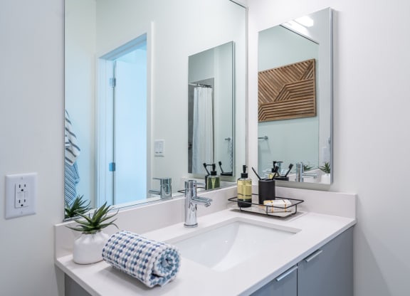 a bathroom with a sink and three mirrors at Union 346, Somerville, 02143