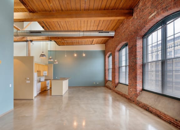 a large room with large windows and a concrete floor