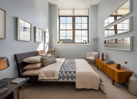 a bedroom with a bed and some windows