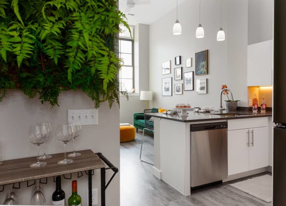 Newly renovated model apartment a kitchen and living room with a table and a sink
