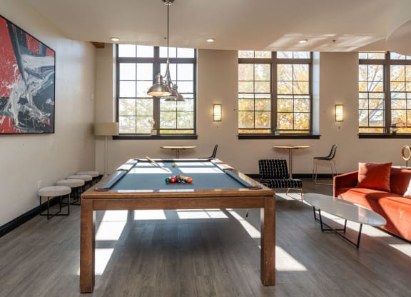 Community lounge at building 240 with pool table and lounge seating