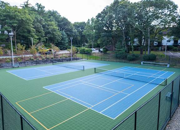 a couple of tennis courts striped for pickleball