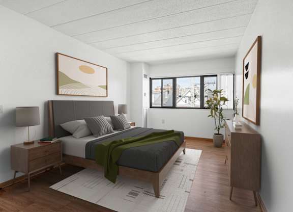 a bedroom with a bed and a window at Bates Hill Apartments Pittsburgh, PA.