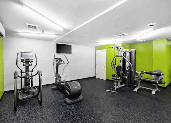 a gym with exercise equipment and green and white wallsat North Stoughton Village, Stoughton, MA