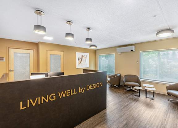 a living well by design lobby with chairs and a reception desk at North Stoughton Village, Massachusetts