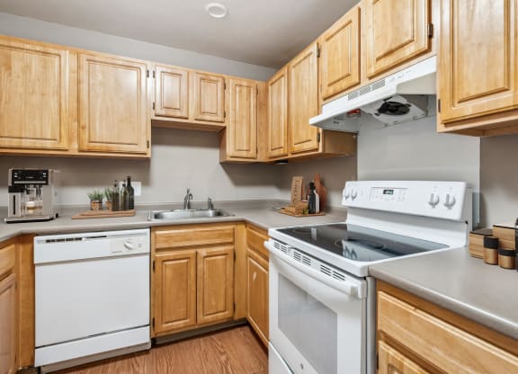 a kitchen with white appliances and wooden cabinets at Chapman House, E. Boston, 02128