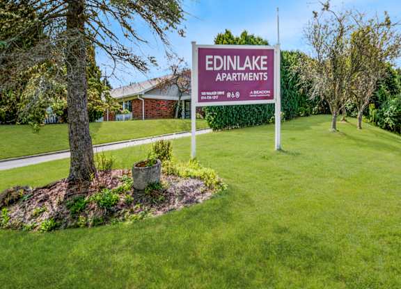 A sign for Edinlake Apartments is displayed in a grassy area.