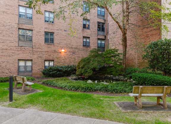 A brick building with a tree in front of it at Branchwood Towers, Clinton