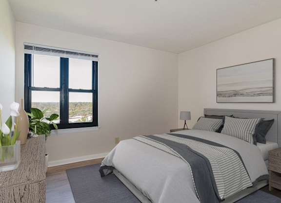 A bedroom with a large bed and a window with a view of the ocean at Branchwood Towers, Clinton