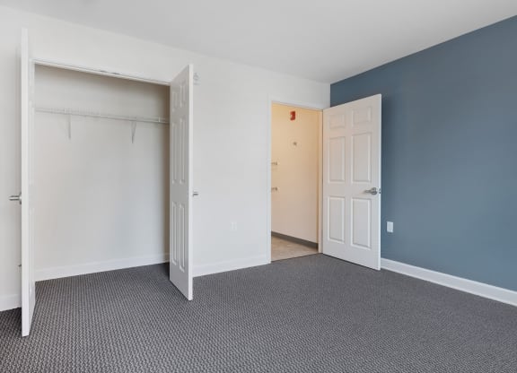 a bedroom with a closet and an open door at Waterfront Apartments, Buffalo
