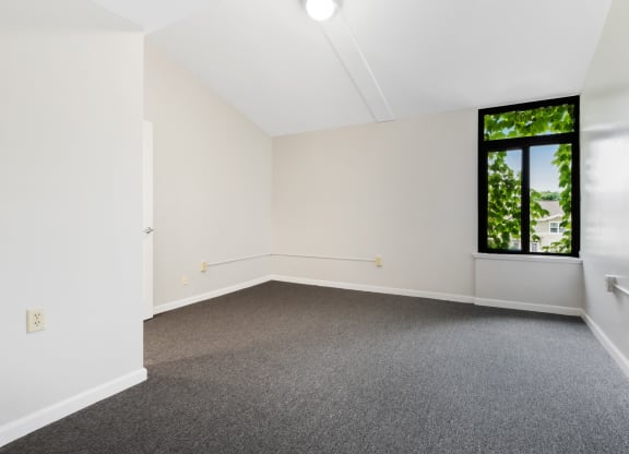 A Bedroom with white walls and a large window  at Shoreline Apartments, Buffalo, New York