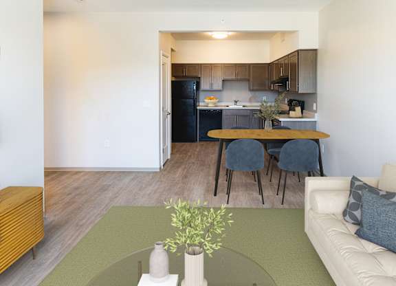 A modern living room with a dining area in the background  at 35 Broadway Apartments, Menands, New York