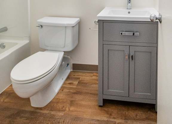 A white toilet and sink in a bathroom at Brewery Square Apartments, New Haven
