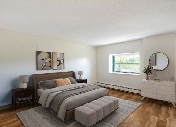 A bedroom with a large bed and a white dresser at Brewery Square Apartments, New Haven , Connecticut