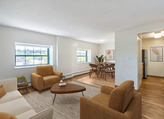 A living room with brown chairs and a brown couch at Brewery Square Apartments, New Haven , CT