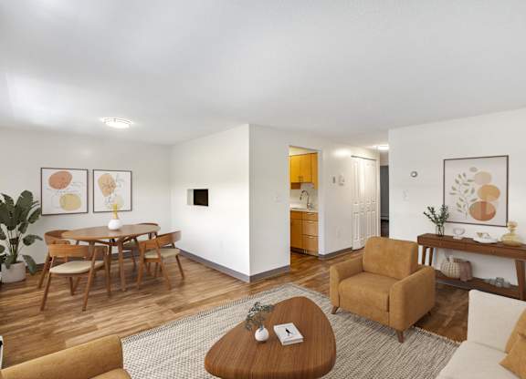 A living room with a brown couch, a coffee table, and a dining table at Brewery Square Apartments, New Haven