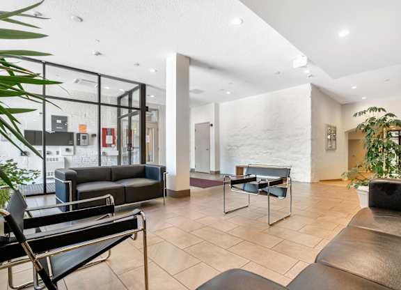 Main entrance lobby with black leather couches and a glass wall at Brewery Square Apartments, New Haven , CT, 06513