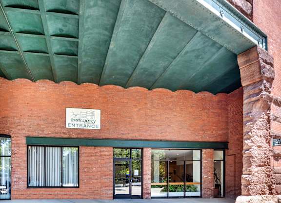The entrance to a building with a sign at Brewery Square Apartments, New Haven , CT, 06513